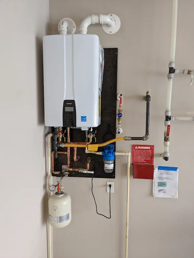 Professional plumber installing copper piping in a Kachina Village home